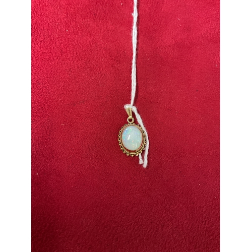 337 - A 9ct gold pendant inset with opal gemstone