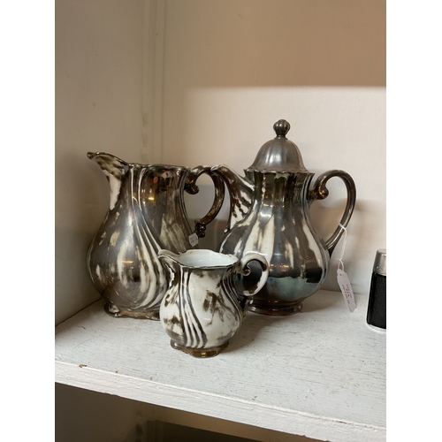 474 - A silver painted china tea-pot, milk jug and cream jug