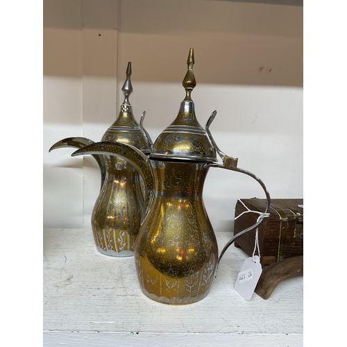 481 - A pair of Middle Eastern brass coffee pots