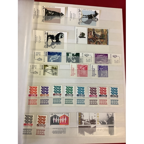 126 - An album housing a selection of stamps unmounted and some mint to include Israel, Palestine, etc