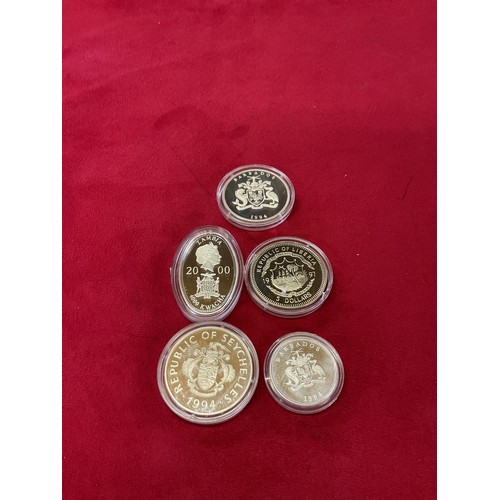 234 - A mixed selection of coins to include five silver proof coins, Seychelles 23 rupees, Liberia 5 dolla... 