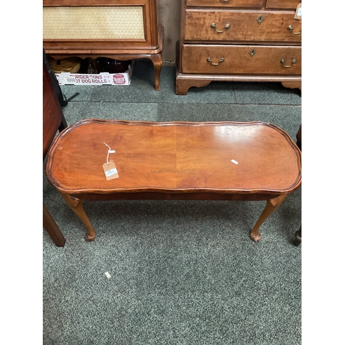 585 - A stained wood shaped top coffee table