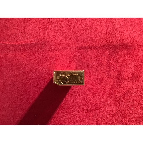 164 - A gold plated Cartier lighter in working order No 1B07376