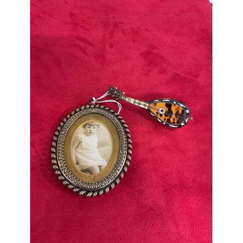 170 - An oval brass rope twist photograph frame together with a miniature tortoiseshell mandolin