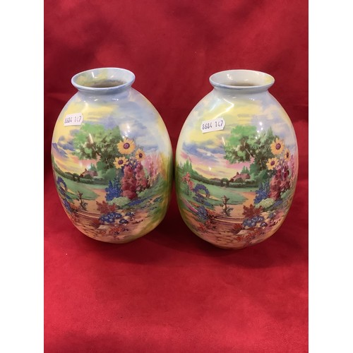 63 - A pair of Crown Ducal vases with garden scene decoration