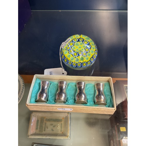 68 - A round glass paperweight together with a box of four silver-plated salt and pepper pot
