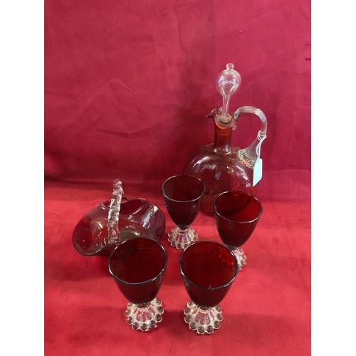 85 - A cranberry glass decanter, four ruby red goblets and a basket