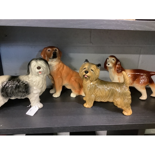 89 - Four ceramic figural dogs to include a Melba ware example