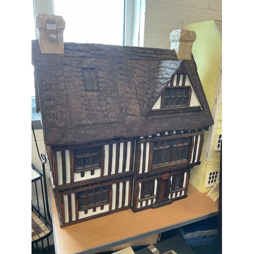 104 - A 1998 Tudor dolls house by Robert Stubbs with provenance and original bill of receipt having detach... 