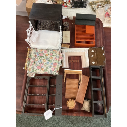 115 - A mixed selection of dolls house furniture to include beds, dresser, fire place etc