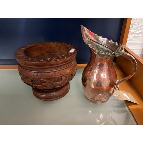 102 - A vintage Middle Eastern copper jug and a carved wooden bowl