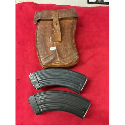 148 - A vintage leather magazine pouch and magazine’s