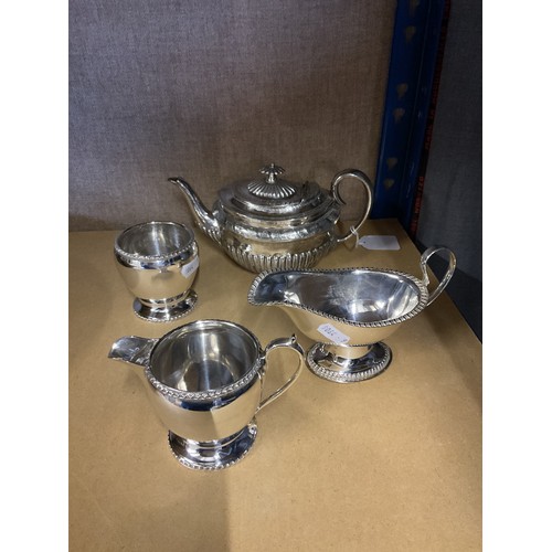 79 - A silver-plated tea pot, milk jug, sauce boat and sugar bowl