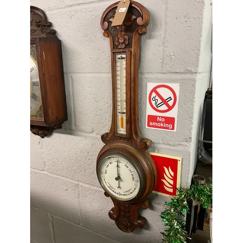 310 - A carved oak cased banjo barometer