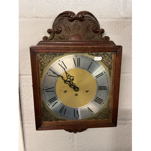 311 - A West German ornately carved wall clock with silvered dial, Roman numerals and eight day movement
