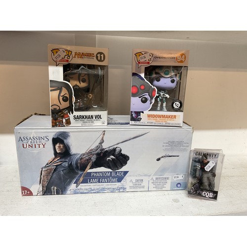 331 - A boxed as new Assassin's Creed Unity 'Phantome Blade' together with a Funko Pop Magic 'Sarkhan' fig... 