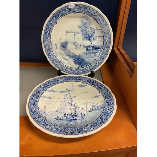 28 - Two Delft by Boch blue and white chargers having pictorial river scene's