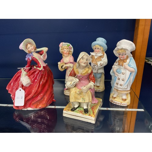 48 - Five china figurines to include a Royal Doulton 'Autumn Breezes' HN1936, a pair of German porcelain ... 