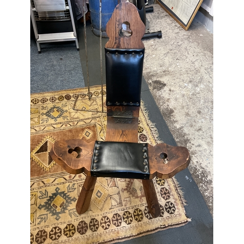336 - A vintage stained wood and leather three leg birthing chair