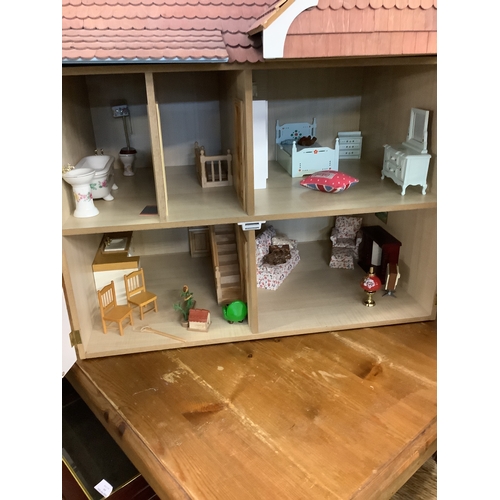 341 - A vintage dolls house with converted attic space and some furnishings