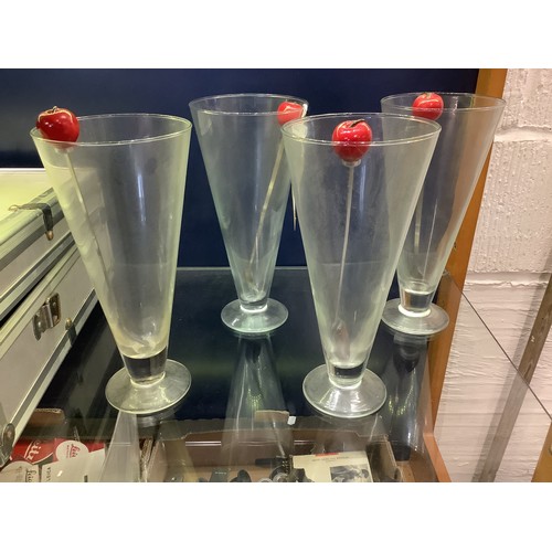 88 - A set of four tall knickerbocker glory sundae dishes with spoons topped with cherries