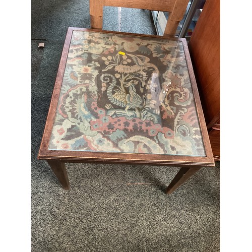 A needlework side table with glass top