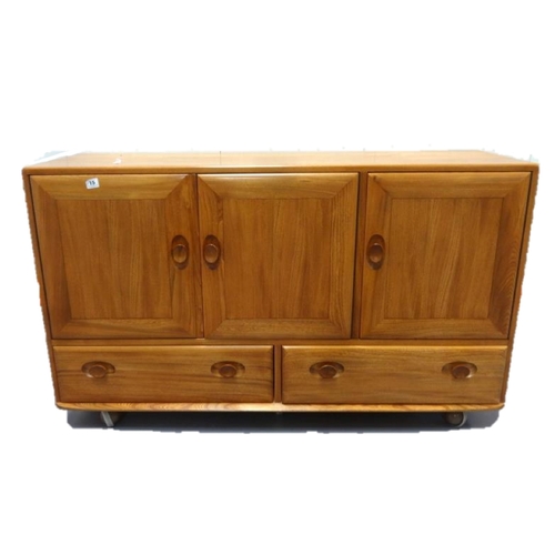 15 - Ercol 3 Door Elm Sideboard with 2 lower drawers, carved wooden pulls, on Shepherds castors