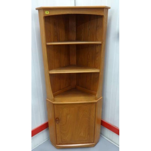 35 - Ercol? Harvest Gold Coloured Elm Standing Corner Cupboard with panelled door, 2 shelves under canopy