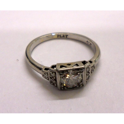 210 - Ladies Platinum Ring with central square setting & facet cut circular diamond with staged diamond se... 