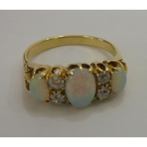 218 - Ladies Yellow Metal (tested 18ct) Opal & Diamond Ring with 3 large central opals, 2 pairs diamonds t... 