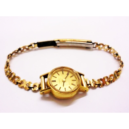 419 - Ladies 18ct Gold Tissot Wristwatch with gilt strap, gold dial, baton markers