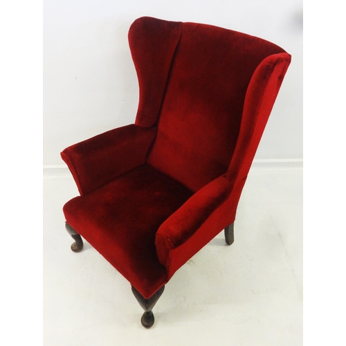 32 - Parker Knoll Wing Armchair on cabriole pad footed supports upholstered in red velour fabric