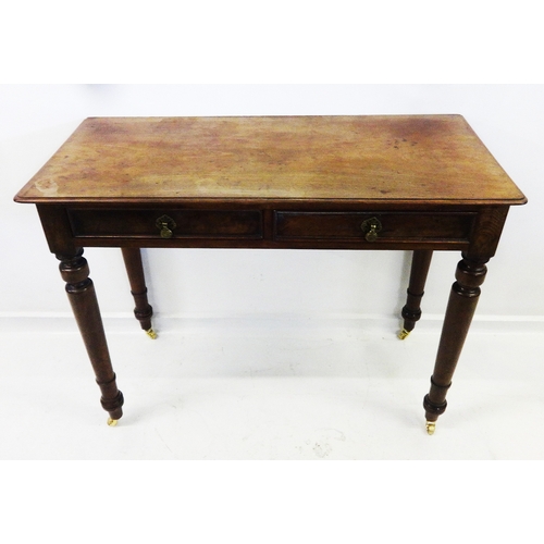 44 - 2 Drawer Writing Table on turned supports with brass castors, moulded drawers, plain mahogany top