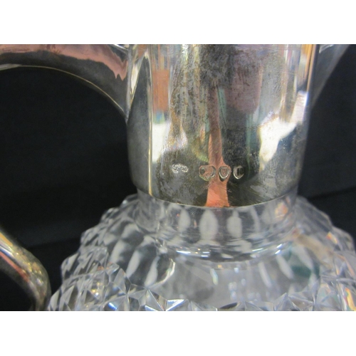 232 - Silver Claret Jug with globe shaped diamond cut body, star cut base, hallmarked London 1890