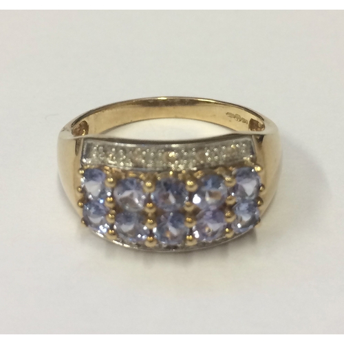 251 - Tanzanite & Diamond Ring, double row tanzanite with diamond surround, set 9ct. gold size P