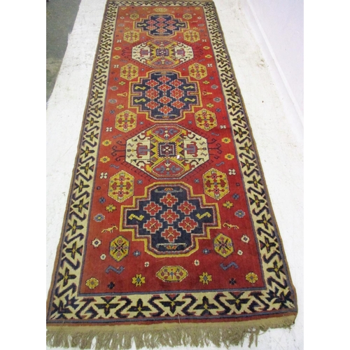 18A - Middle Eastern Carpet Runner with deep salmon ground, geometric & abstract motifs, tassel ends, appr... 