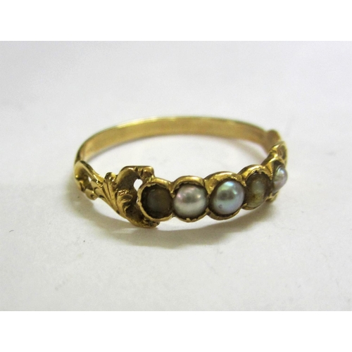 489 - Unmarked Yellow Metal C19th Ring set 5 seed pearls with decorative pierced shoulders