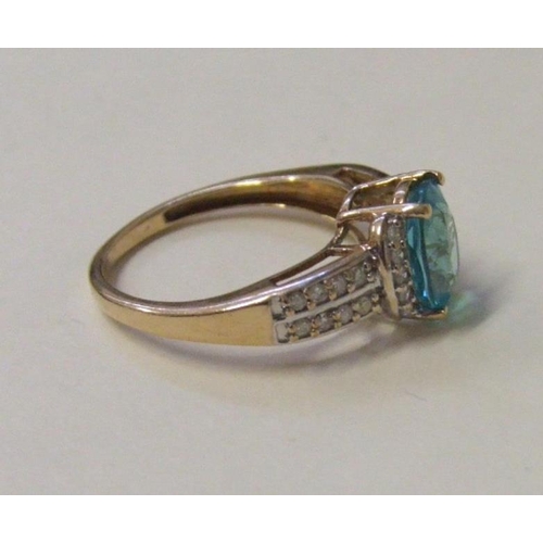 506 - 9ct. Gold Blue Topaz & Diamond Ring, central stone approx. 90mm Long, with 5 cresecent set diamonds ... 