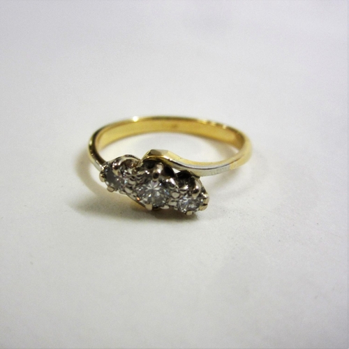 216 - 18ct. Gold 3 Stone Diamond Cross Over Ring on split shank size N 1/2