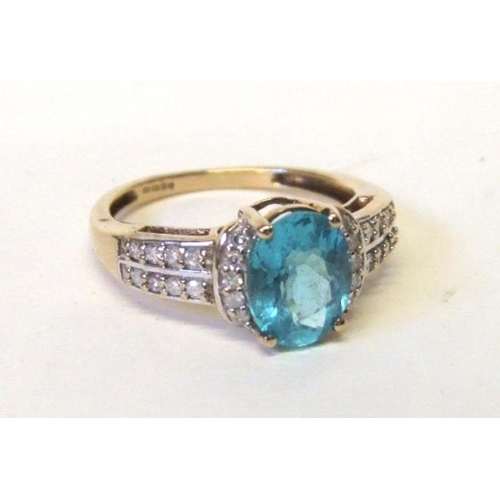 231 - 9ct. Gold Blue Topaz & Diamond set Ring, central bright blue stone set with diamonds either side & a... 