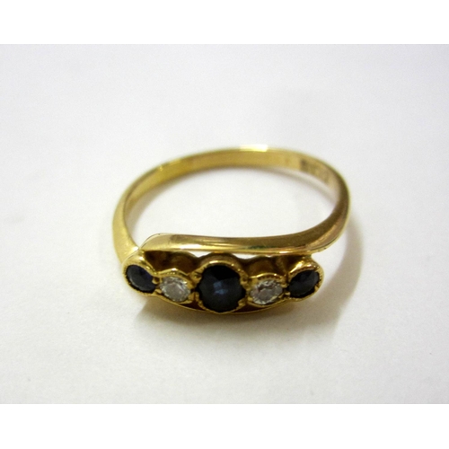 218 - 18ct. Gold Sapphire & Diamond Ring in cross over setting, central oval sapphire with circular sapphi... 