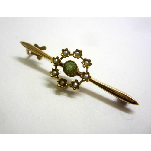 220 - 15ct. Gold Seed Pearl & Peridot Bar Brooch, central peridot surrounded by floral set seed pearls