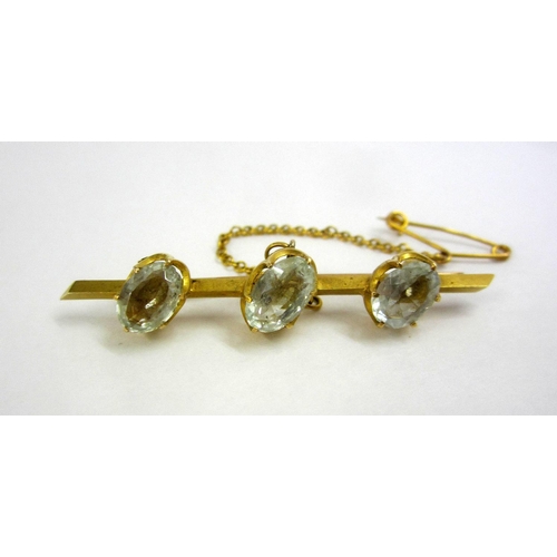 227 - 15ct Gold Bar Brooch with angled bar set 3 pale oval facet cut aquamarines, with safety chain