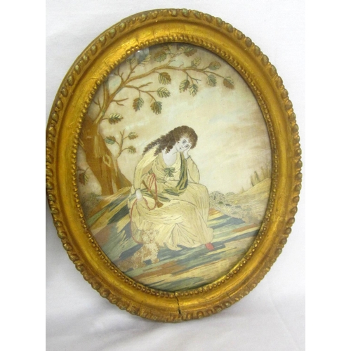 292 - Pair Gilt Framed Oval Embroidered Panels: young lady sitting with dog by a tree & young lady holding... 