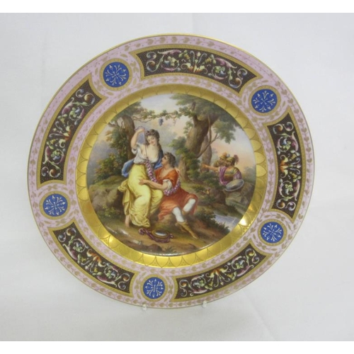 335 - C19th Vienna Porcelain Dished Plate decorated with lovers in garden, small pond, lilac border panels... 