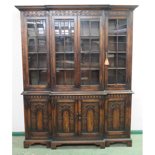 115 - Breakfront Library Bookcase with Four arched carved Doors, Glazed superstructure with wooden shelves... 