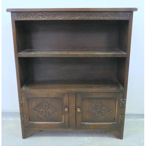 55A - Priory Oak Style Book case with 2 cupboard doors under on bracket supports, with carved top frieze &... 