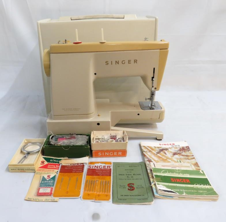 Cream Plastic Cased Singer Sewing Machine with additional instructions