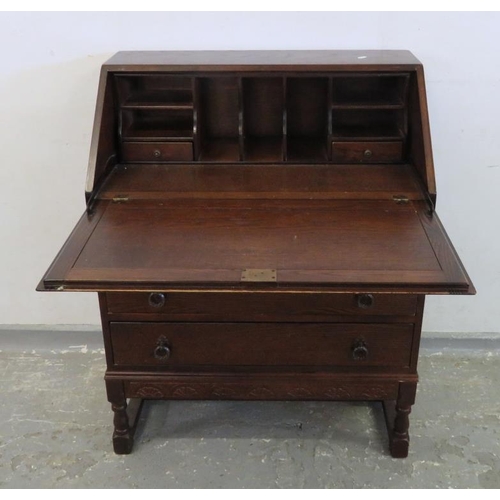 44 - Oak Bureau with carved frieze to base, 2 carved panel to top, 2 long drawers & shorter drawer under,... 
