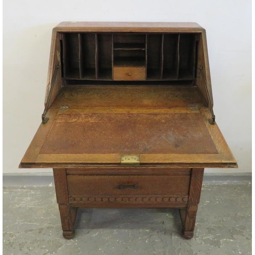 89 - Small Oak Bureau, fall with carved decoration enclosing fitted nest over 3 long drawers (A5)